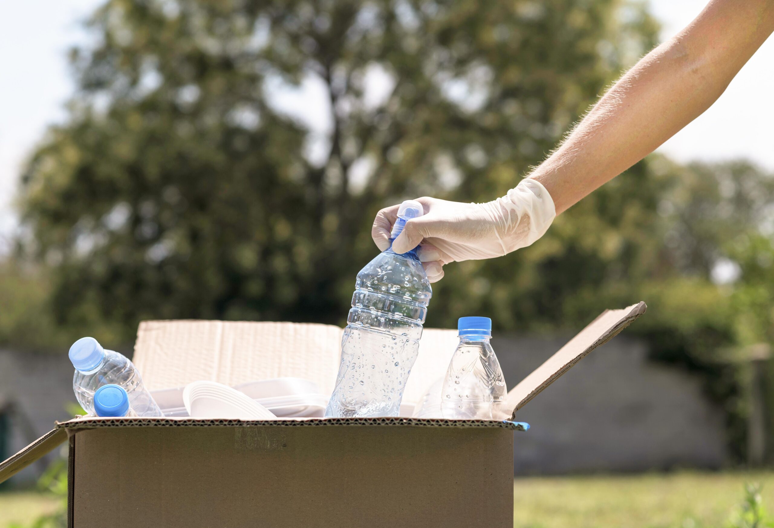 close-up-individual-recycling-plastic-bottles